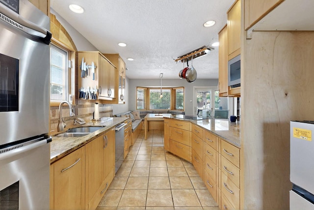 7313 Valley Forge Rd NE, Albuquerque, NM 87109 - kitchen with a sink, dishwasher, a textured ceiling, refrigerator, and decorative light fixtures