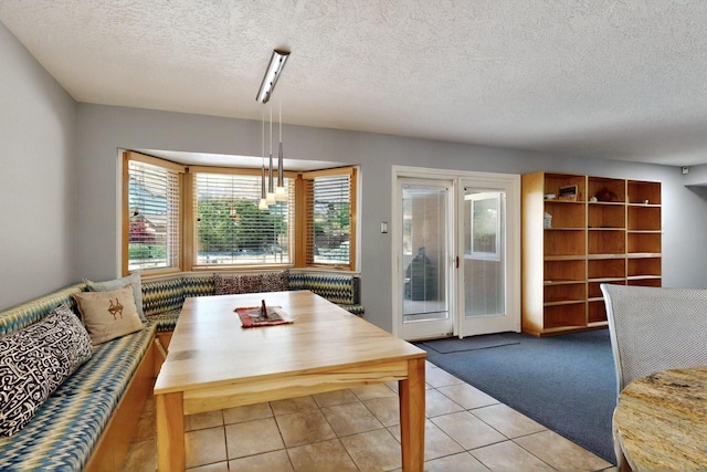 7313 Valley Forge Rd NE, Albuquerque, NM 87109 - dining room featuring a textured ceiling, light tile patterned flooring, and light carpet
