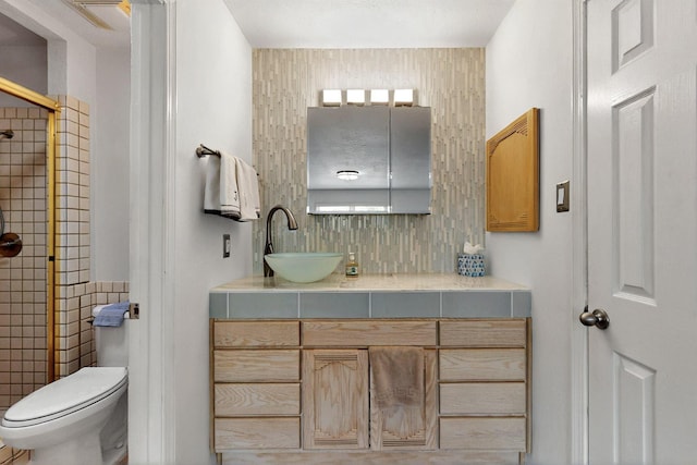 7313 Valley Forge Rd NE, Albuquerque, NM 87109 - bathroom with vanity, a tile shower, decorative backsplash, and toilet