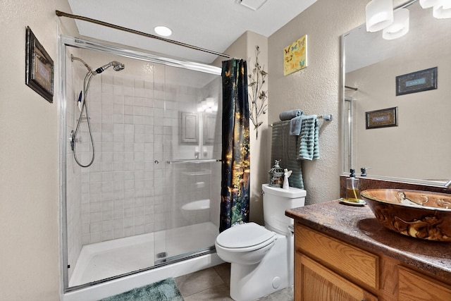 3039 Ashkirk Loop SE, Rio Rancho, NM 87124 - full bath with toilet, a shower stall, vanity, tile patterned floors, and a textured wall