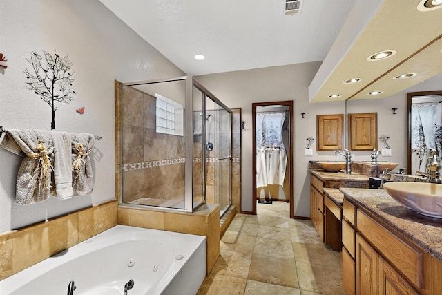 3039 Ashkirk Loop SE, Rio Rancho, NM 87124 - bathroom featuring a stall shower, double vanity, baseboards, a jetted tub, and stone tile flooring
