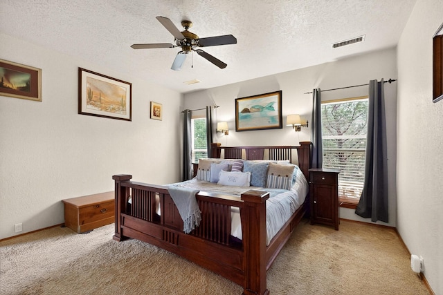 3039 Ashkirk Loop SE, Rio Rancho, NM 87124 - bedroom with light colored carpet, a textured ceiling, a ceiling fan, and baseboards