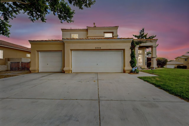 3039 Ashkirk Loop SE, Rio Rancho, NM 87124 - mediterranean / spanish house with a garage, stucco siding, concrete driveway, and a front lawn