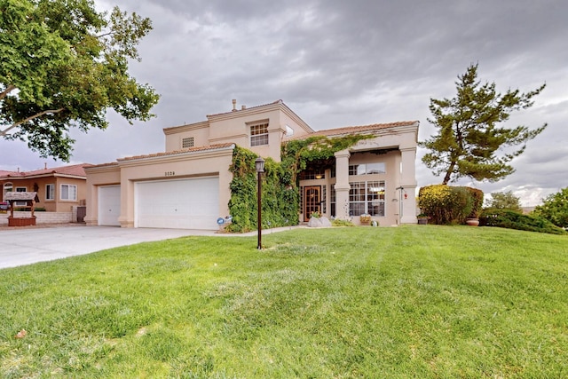 3039 Ashkirk Loop SE, Rio Rancho, NM 87124 - mediterranean / spanish-style house featuring a front lawn, an attached garage, concrete driveway, and stucco siding