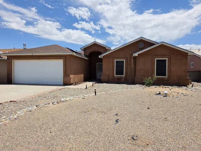 8 Revelations Pl SW, Los Lunas, NM 87031 - ranch-style house with concrete driveway, a garage, and stucco siding