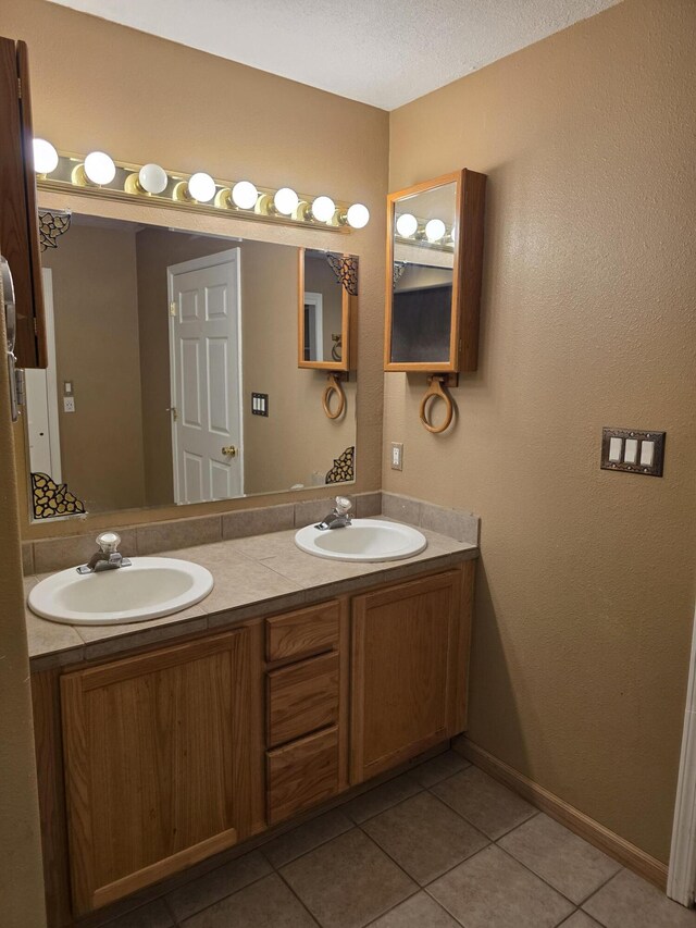 8 Revelations Pl SW, Los Lunas, NM 87031 - bathroom with double vanity, tile patterned flooring, and a textured ceiling