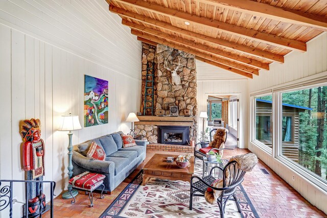 78 Slate Rd, Jemez Springs, NM 87025 - living room featuring brick floors, a stone fireplace, wood ceiling, and wood walls