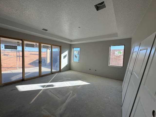 6921 Archer Rd, Rio Rancho, NM 87144 - spare room featuring a textured ceiling, plenty of natural light, and a tray ceiling