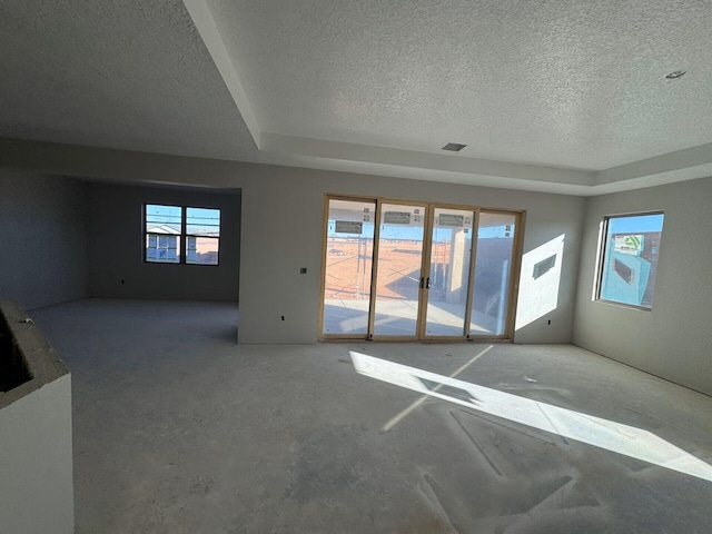 6921 Archer Rd, Rio Rancho, NM 87144 - empty room featuring a textured ceiling and a tray ceiling
