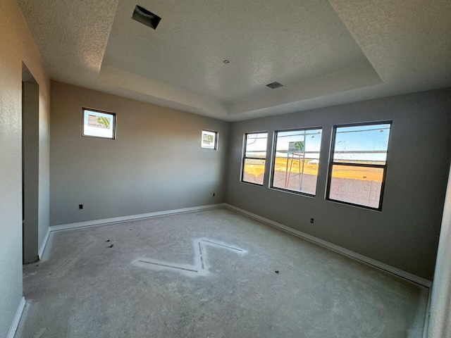 6921 Archer Rd, Rio Rancho, NM 87144 - spare room featuring a tray ceiling, a textured ceiling, healthy amount of natural light, and baseboards