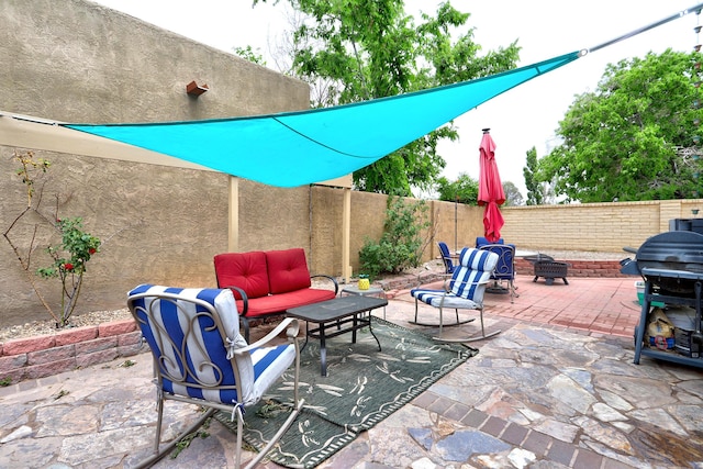 589 Diez Y Ocho Ct SE, Rio Rancho, NM 87124 - fenced backyard featuring a patio, an outdoor living space with a fire pit, and a grill