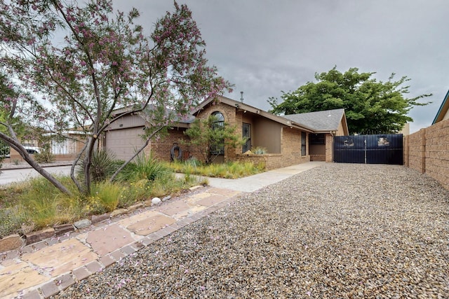 6322 Lamy St NW, Albuquerque, NM 87120 - view of front of home with brick siding and a garage