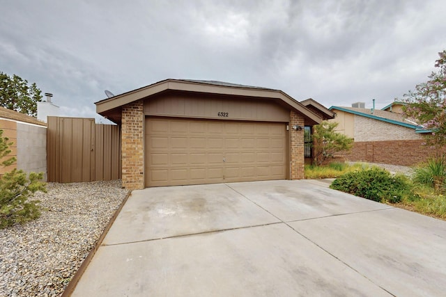 6322 Lamy St NW, Albuquerque, NM 87120 - mid-century inspired home featuring brick siding, concrete driveway, and an attached garage
