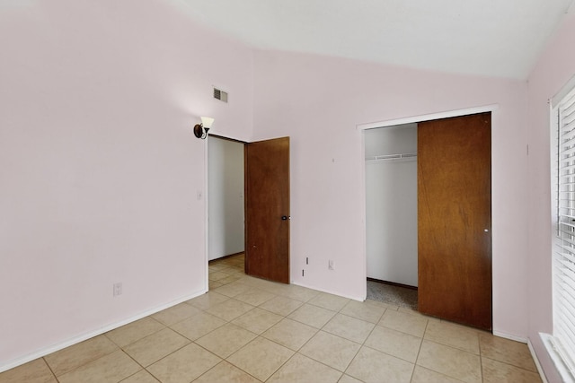 6322 Lamy St NW, Albuquerque, NM 87120 - unfurnished bedroom with vaulted ceiling, a closet, light tile patterned flooring, and baseboards