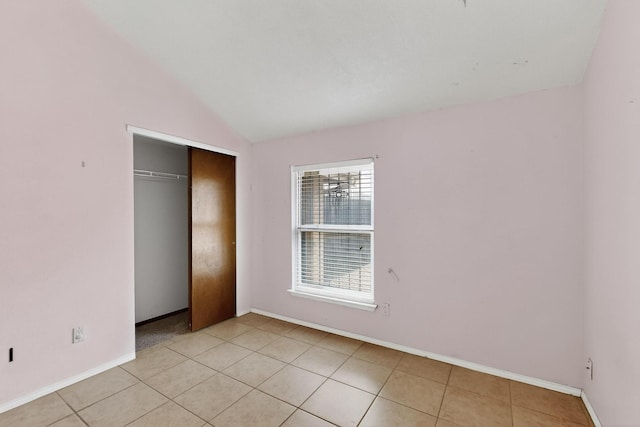 6322 Lamy St NW, Albuquerque, NM 87120 - unfurnished bedroom featuring lofted ceiling, light tile patterned floors, baseboards, and a closet