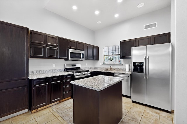 6322 Lamy St NW, Albuquerque, NM 87120 - kitchen featuring stainless steel appliances, a high ceiling, light tile patterned floors, a kitchen island, and recessed lighting