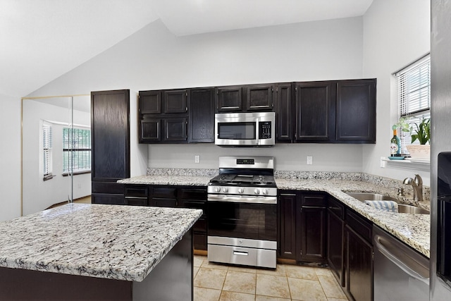 6322 Lamy St NW, Albuquerque, NM 87120 - kitchen with appliances with stainless steel finishes, a sink, lofted ceiling, light stone countertops, and a center island