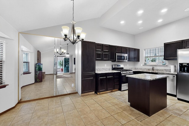 6322 Lamy St NW, Albuquerque, NM 87120 - kitchen with appliances with stainless steel finishes, high vaulted ceiling, a chandelier, light tile patterned floors, and recessed lighting