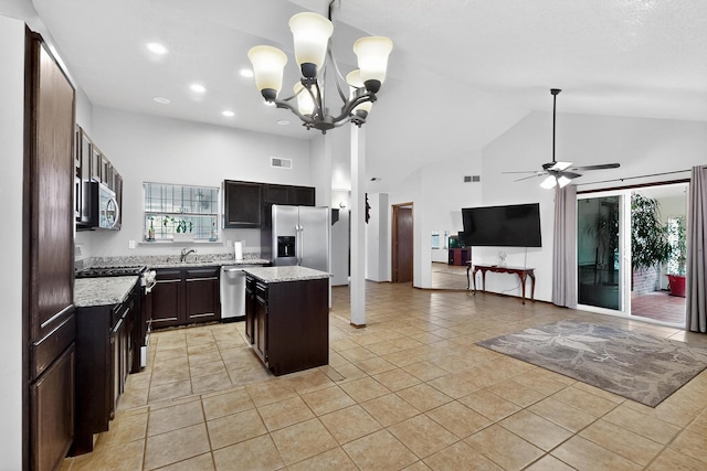 6322 Lamy St NW, Albuquerque, NM 87120 - kitchen with appliances with stainless steel finishes, a sink, high vaulted ceiling, open floor plan, and light tile patterned floors