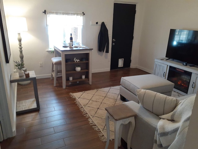 711 Lewis Ave SE, Albuquerque, NM 87102 - living room featuring hardwood / wood-style flooring, baseboards, and a glass covered fireplace