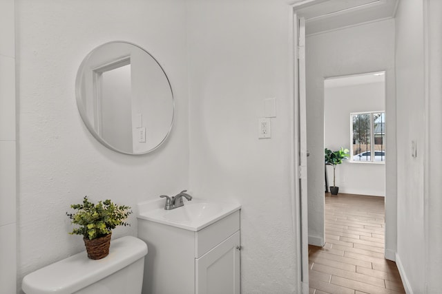 711 Lewis Ave SE, Albuquerque, NM 87102 - bathroom featuring vanity, toilet, and baseboards