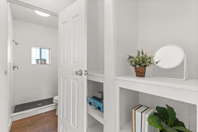 711 Lewis Ave SE, Albuquerque, NM 87102 - full bathroom with a shower stall, wood finished floors, and toilet