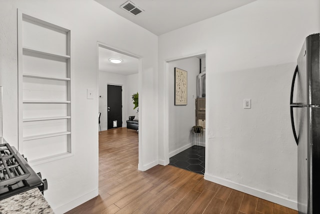 711 Lewis Ave SE, Albuquerque, NM 87102 - kitchen featuring freestanding refrigerator, baseboards, dark wood-style flooring, and built in shelves