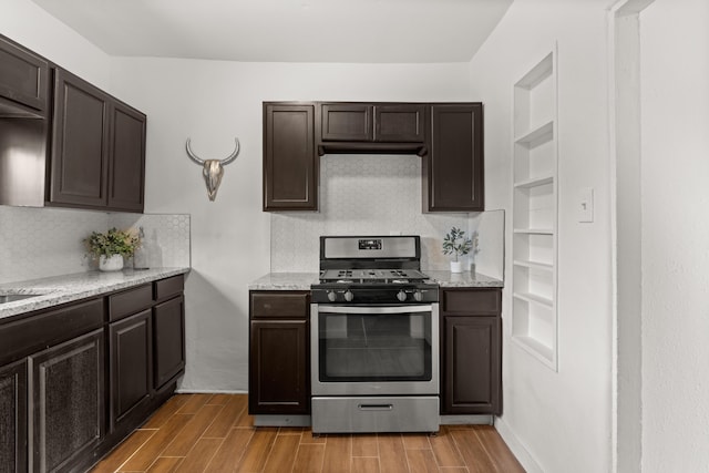 711 Lewis Ave SE, Albuquerque, NM 87102 - kitchen featuring gas stove, light wood finished floors, dark brown cabinets, and backsplash