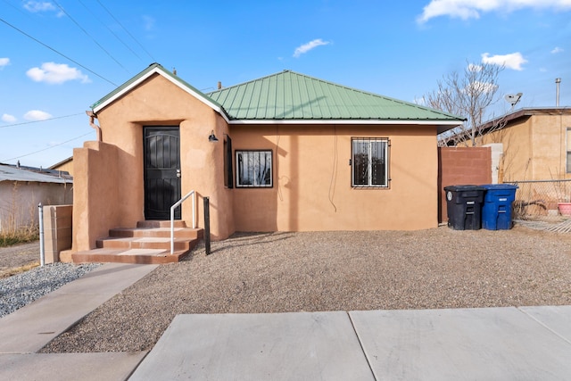 711 Lewis Ave SE, Albuquerque, NM 87102 - view of front facade with stucco siding and metal roof