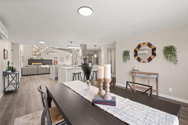 11701 Summer Ave NE, Albuquerque, NM 87112 - dining area with baseboards, wood finished floors, and an AC wall unit