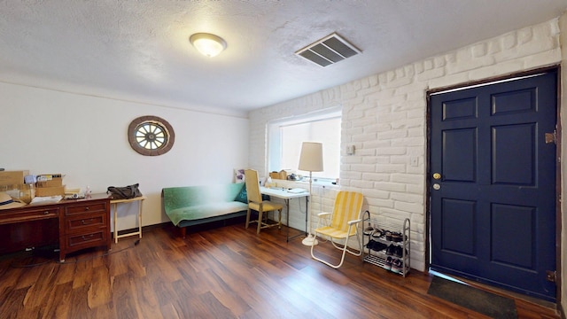 1207 Barelas Rd SW, Albuquerque, NM 87102 - office featuring wood finished floors, a textured ceiling, and brick wall