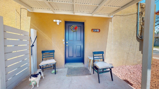 1207 Barelas Rd SW, Albuquerque, NM 87102 - view of exterior entry featuring stucco siding and a porch