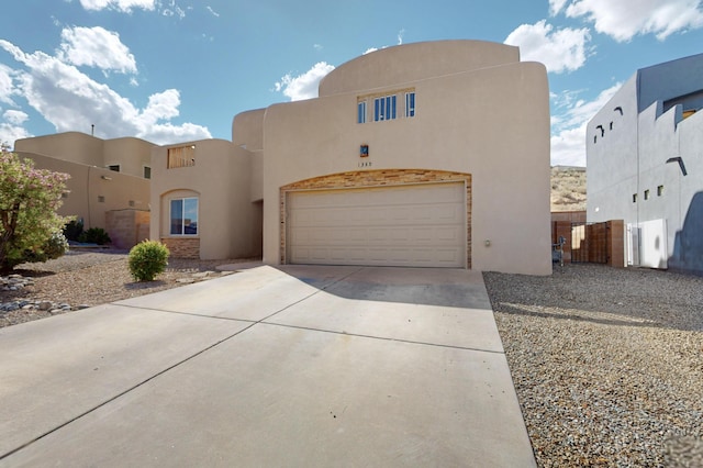 1365 Wilkes Way SE, Rio Rancho, NM 87124 - southwest-style home featuring stucco siding, driveway, and a garage