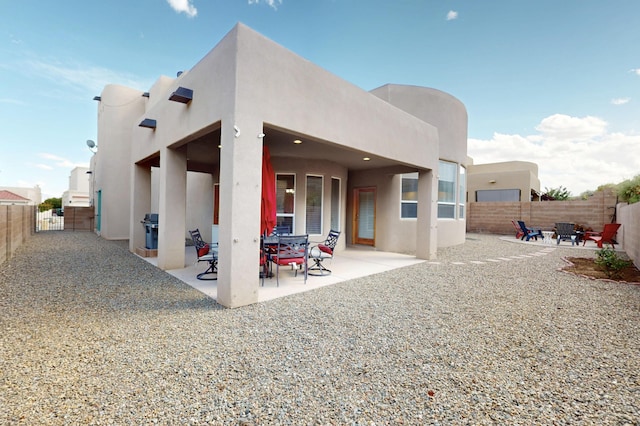 1365 Wilkes Way SE, Rio Rancho, NM 87124 - rear view of property with stucco siding, a fenced backyard, and a patio area