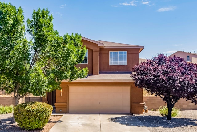 1343 San Juan Ct NE, Rio Rancho, NM 87144 - view of front of house with stucco siding, a garage, and driveway
