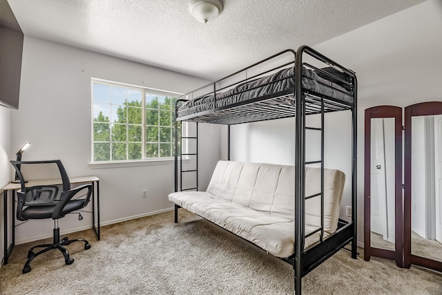 1343 San Juan Ct NE, Rio Rancho, NM 87144 - carpeted bedroom featuring a textured ceiling and a desk