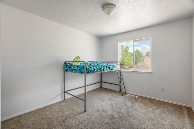 1343 San Juan Ct NE, Rio Rancho, NM 87144 - unfurnished bedroom with carpet floors and a textured ceiling