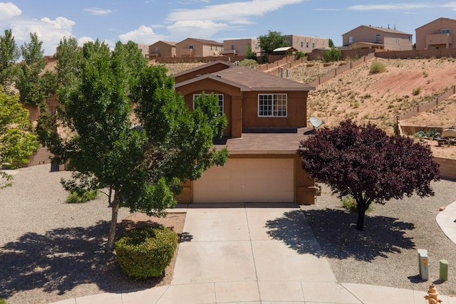 1343 San Juan Ct NE, Rio Rancho, NM 87144 - adobe home with a garage, driveway, stucco siding, and a residential view