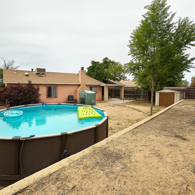3901 70th St NW, Albuquerque, NM 87120 - view of swimming pool featuring central AC and a patio