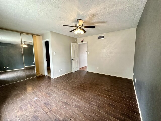 3901 70th St NW, Albuquerque, NM 87120 - unfurnished bedroom featuring a textured ceiling, wood finished floors, baseboards, a ceiling fan, and a closet
