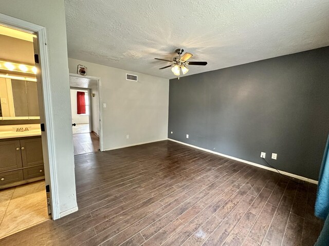 3901 70th St NW, Albuquerque, NM 87120 - unfurnished room featuring ceiling fan, wood finished floors, a textured ceiling, baseboards, and a sink