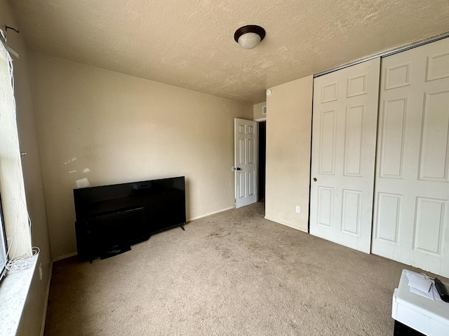 3901 70th St NW, Albuquerque, NM 87120 - unfurnished bedroom with a closet, a textured ceiling, carpet, and baseboards