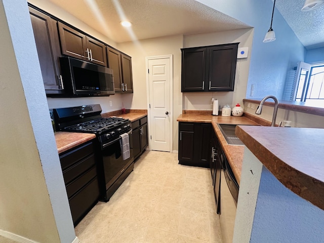 6275 Nueva Espana Rd NW, Albuquerque, NM 87114 - kitchen featuring black appliances, a sink, a textured ceiling, hanging light fixtures, and light tile patterned floors
