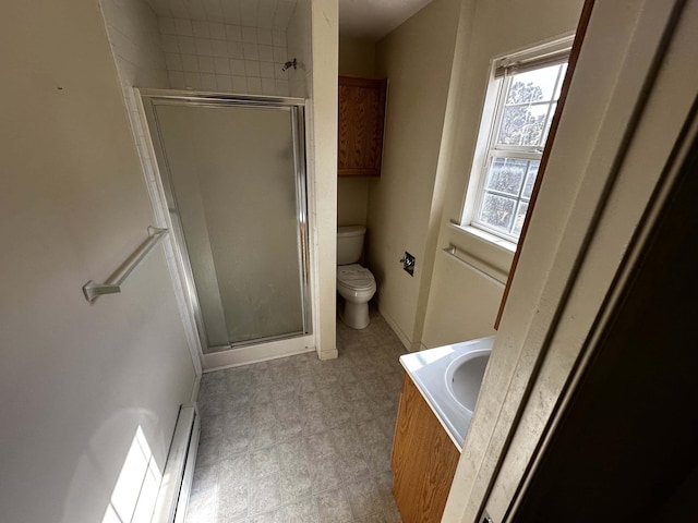 169 Wildwood Trl, Datil, NM 87821 - bathroom with toilet, baseboard heating, a stall shower, and vanity