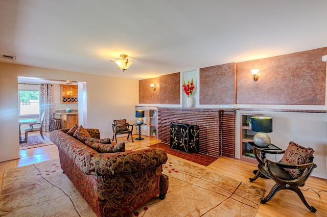 7909 Rancho De Roberto Rd NW, Albuquerque, NM 87114 - living room with wood finished floors and a fireplace