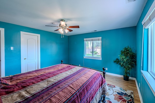 7909 Rancho De Roberto Rd NW, Albuquerque, NM 87114 - bedroom with wood finished floors, baseboards, and ceiling fan