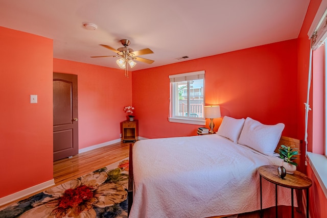 7909 Rancho De Roberto Rd NW, Albuquerque, NM 87114 - bedroom with wood finished floors, baseboards, and ceiling fan