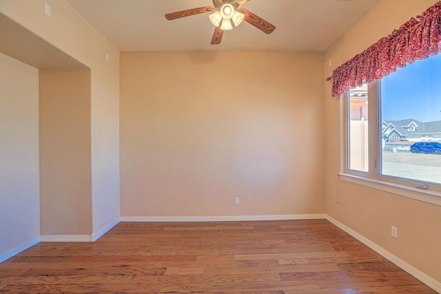 1624 23rd Ave SE, Rio Rancho, NM 87124 - empty room featuring wood finished floors, a ceiling fan, and healthy amount of natural light