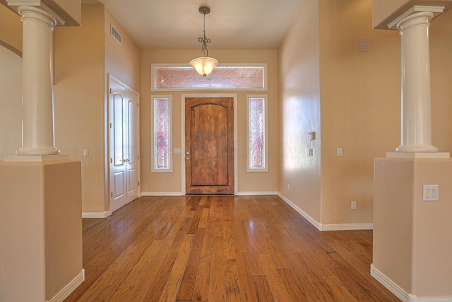1624 23rd Ave SE, Rio Rancho, NM 87124 - foyer featuring ornate columns, hardwood / wood-style floors, and plenty of natural light