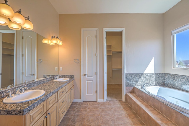 1624 23rd Ave SE, Rio Rancho, NM 87124 - full bath featuring double vanity, a garden tub, a spacious closet, and tile patterned flooring